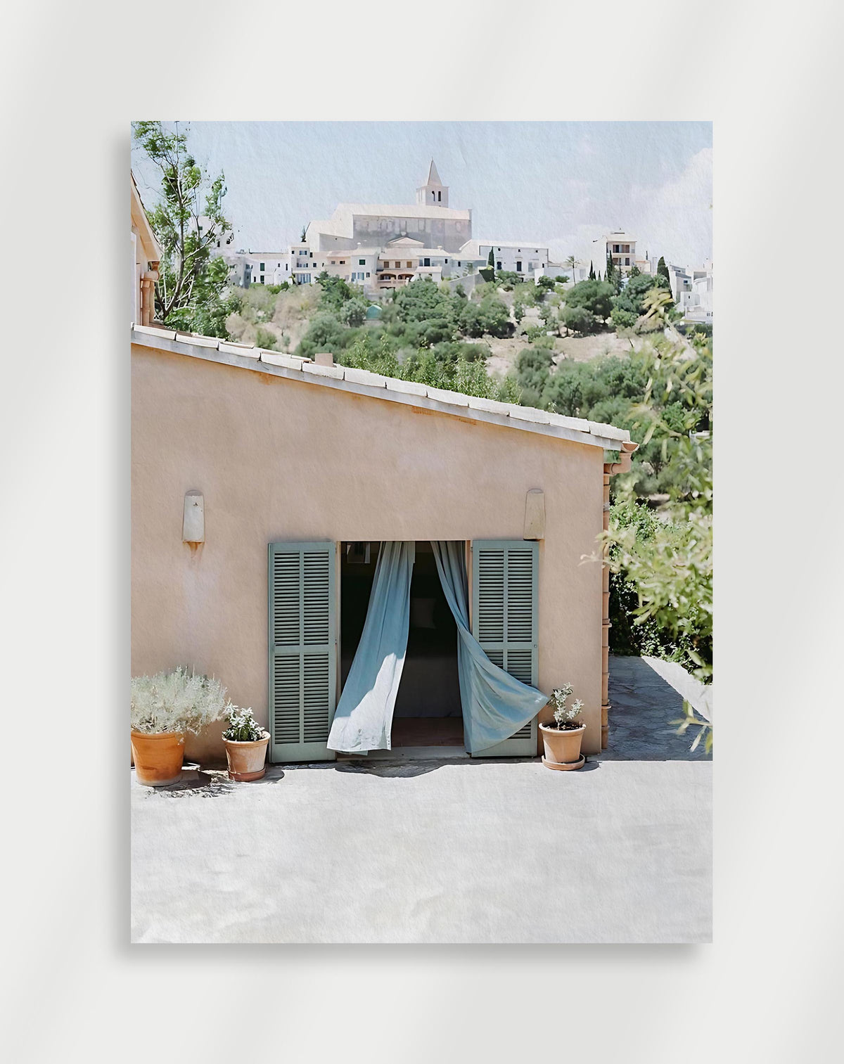 Blue shutters hill town poster with a peach building with blue shutters overlooking a white hill town
