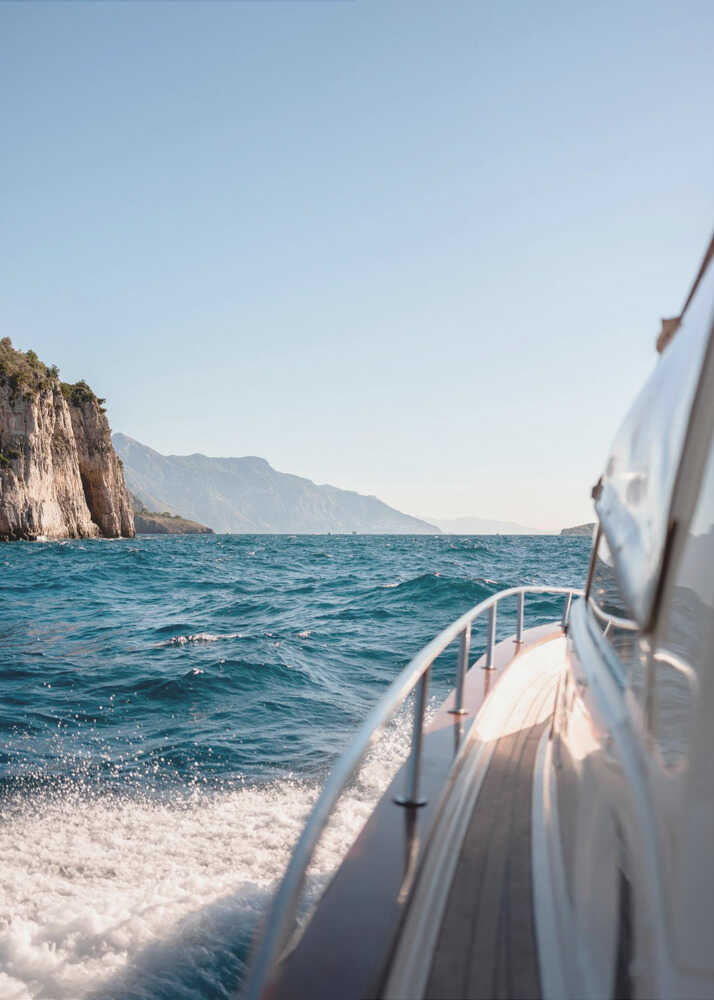 Boat cliffs poster with a view from a boat of blue sea cliffs and mountains