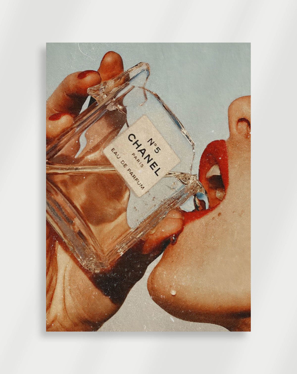Chanel No5 poster with a close-up of a Chanel No. 5 perfume bottle held to red lips