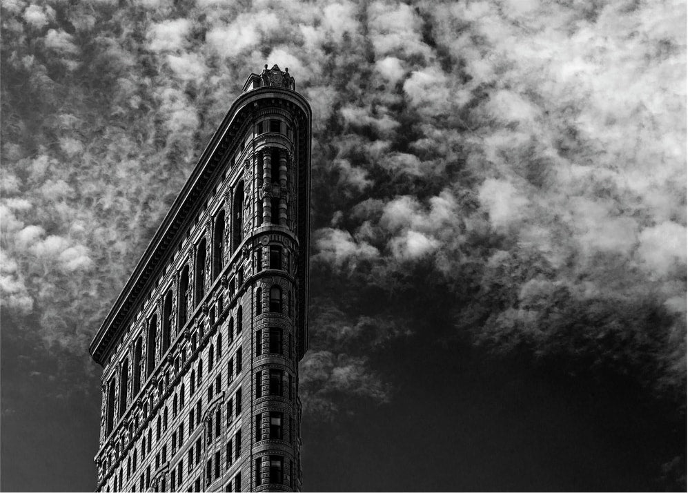 Flatiron Building clouds poster with a black and white low-angle view of the Flatiron Building against clouds