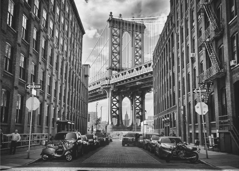 Manhattan Bridge street poster with a black and white view of the Manhattan Bridge between buildings