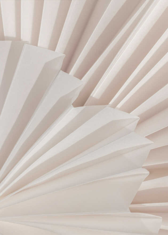 Minimalist pleated paper photo poster with a close-up photograph of white paper folded into a fan design