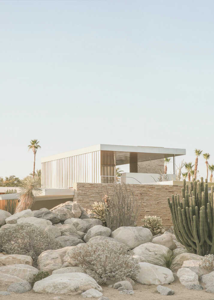 Modern desert house poster with a modern house among rocks, cacti and palm trees