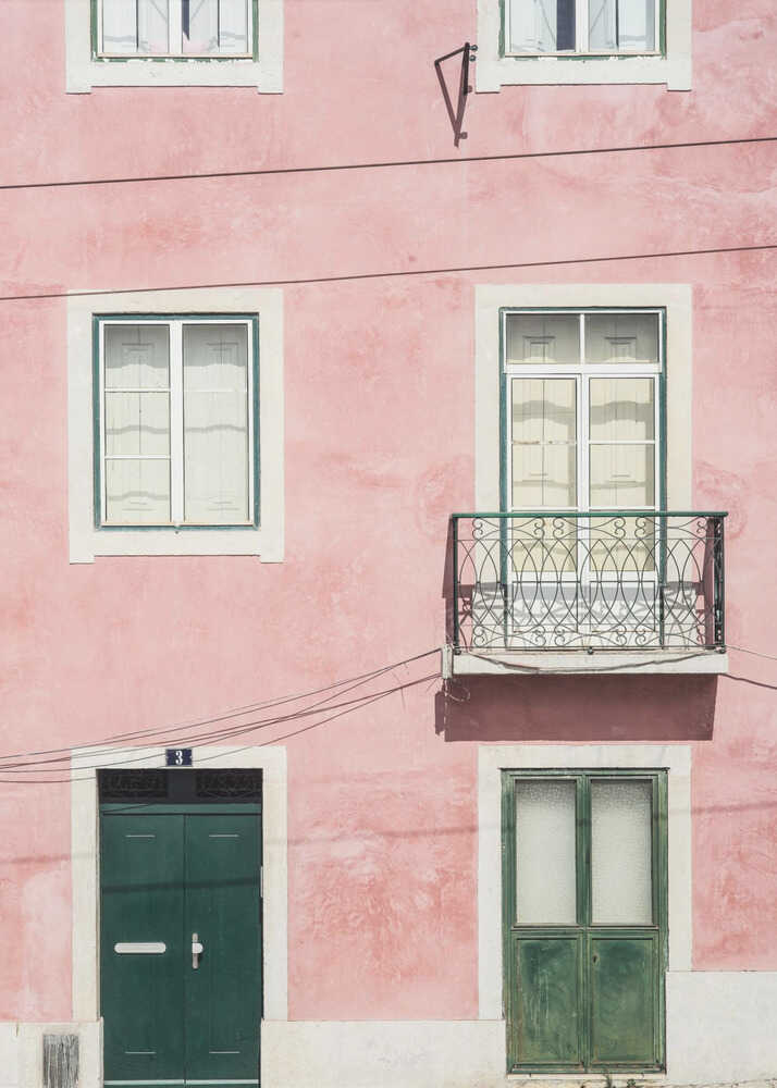 Pink building facade poster with a pink facade green doors and a small balcony