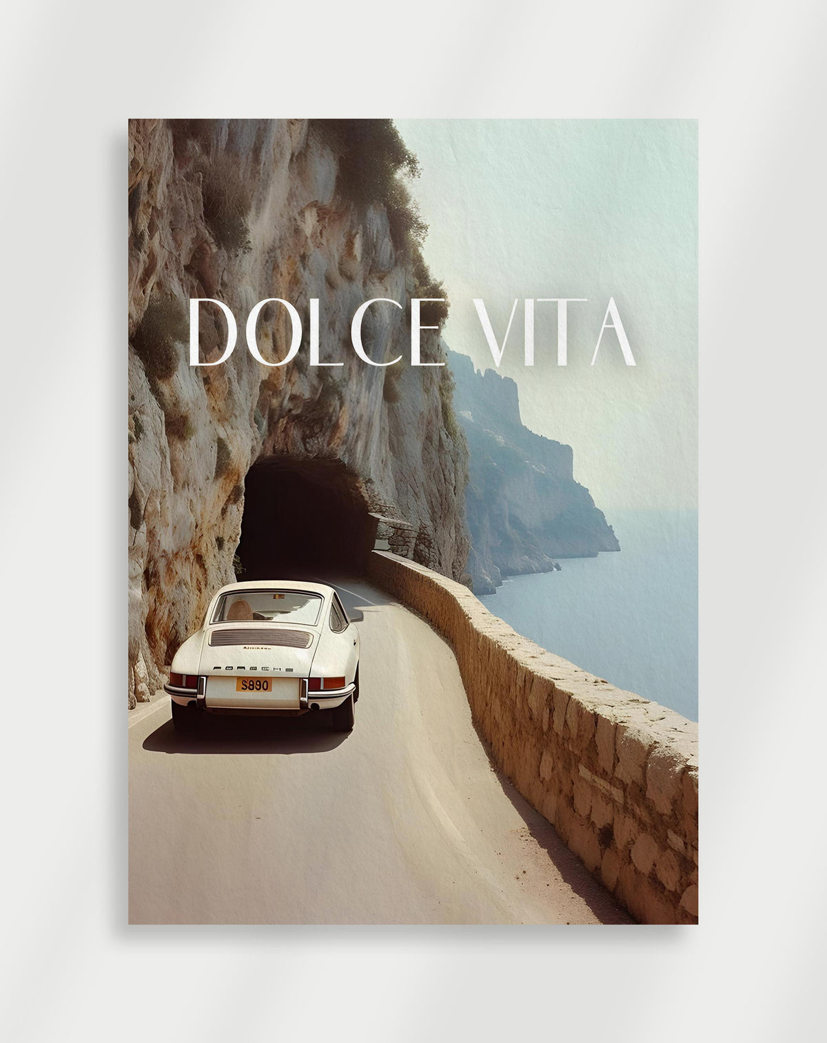Porsche coastal road poster with a white Porsche on a coastal road by a cliff with DOLCE VITA text