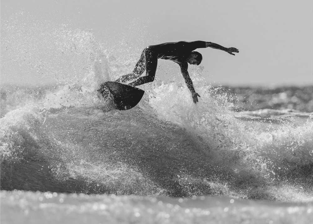 Surfer wave poster with a black and white view of a surfer riding a wave