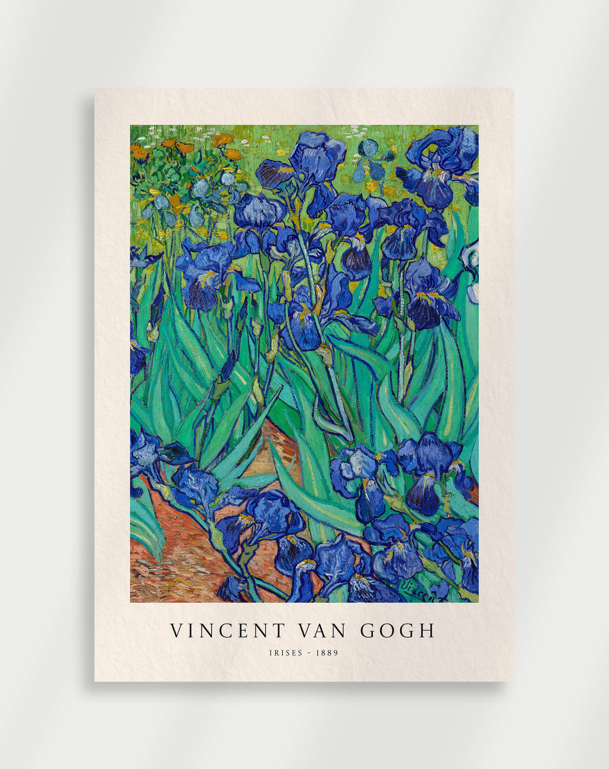 Vibrant irises with rich blue tones and detailed green leaves by Vincent van Gogh
