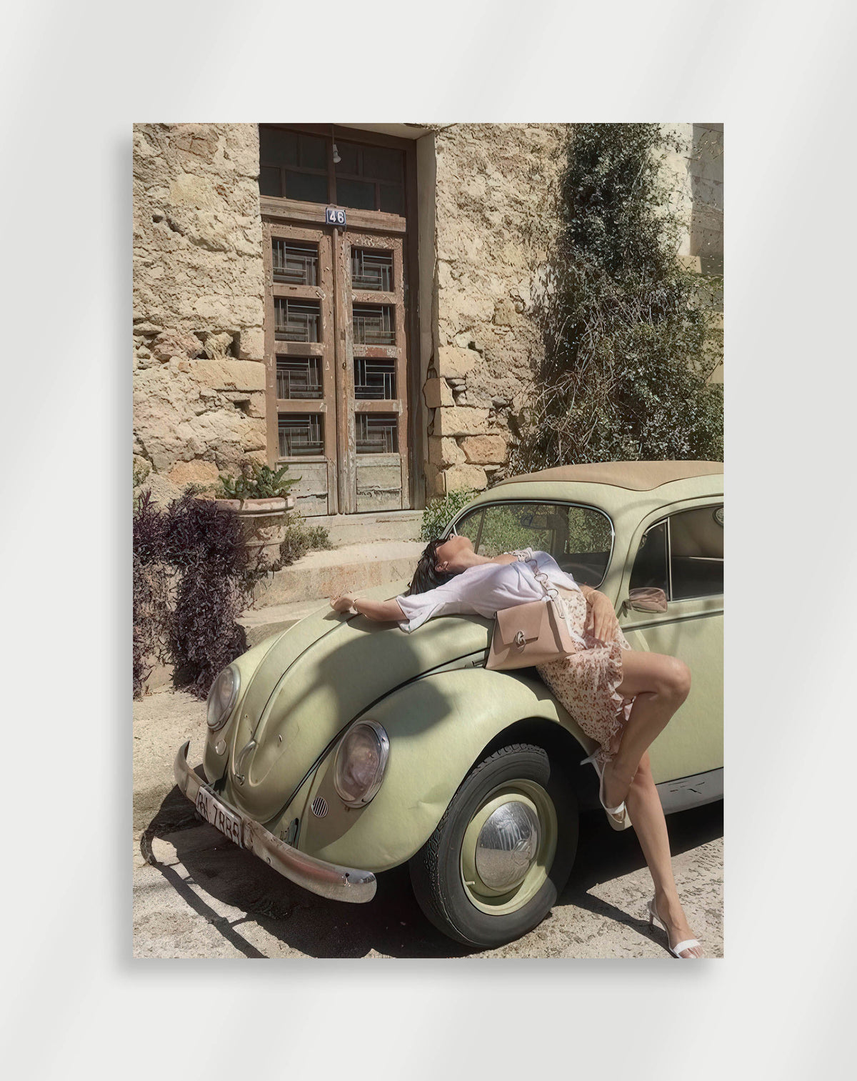 Woman green beetle poster with a woman lying on the hood of a pale green vintage Volkswagen Beetle